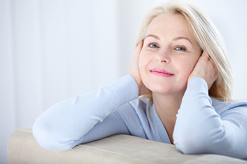 Revision skincare | photo of active beautiful middle-aged woman smiling